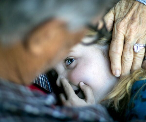 Grandparents holding granddaughter