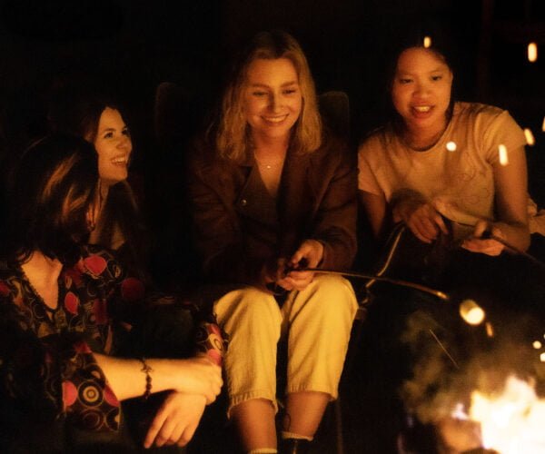 Teens around campfire